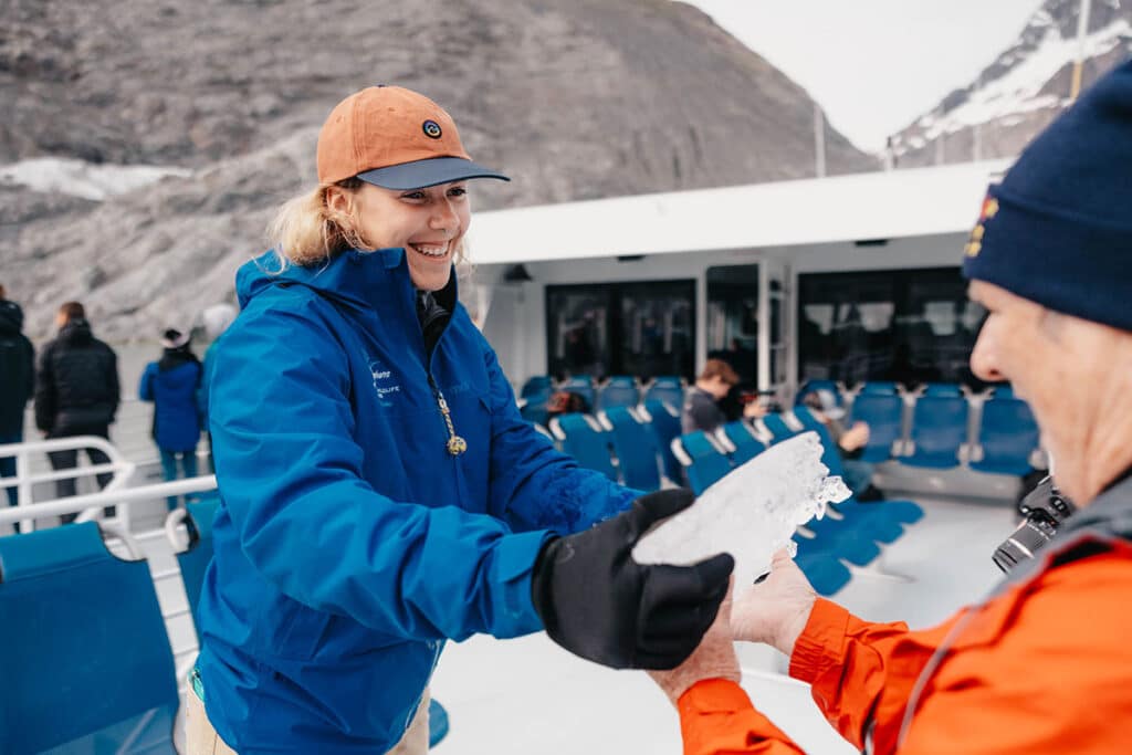 Woman giving a piece of ice to someone
